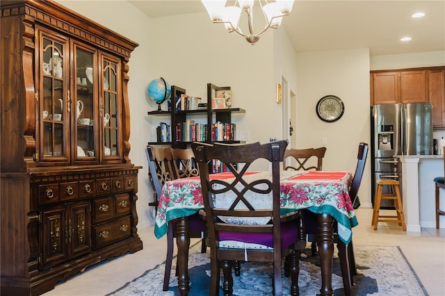 carpeted dining room with a chandelier