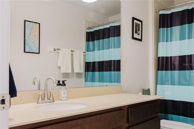 bathroom featuring vanity, a shower with shower curtain, and toilet