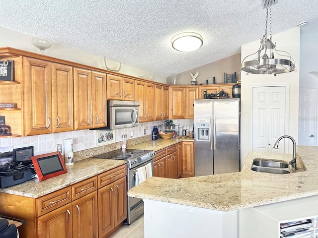 kitchen with light stone countertops, appliances with stainless steel finishes, a textured ceiling, sink, and decorative light fixtures