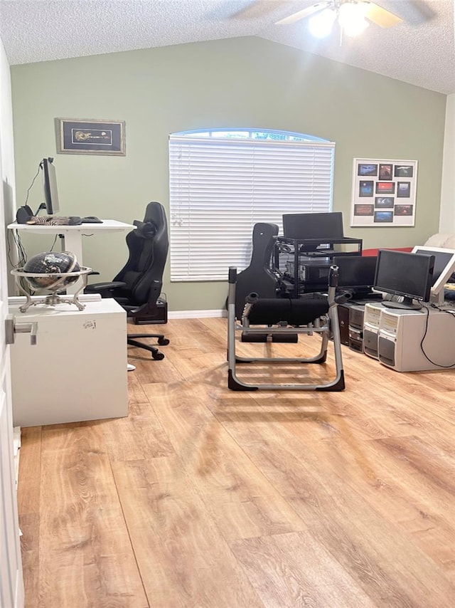 office with a textured ceiling, light hardwood / wood-style floors, and vaulted ceiling