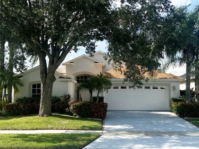 view of front facade featuring a front yard and a garage