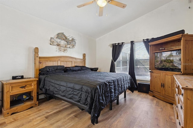 bedroom with lofted ceiling, ceiling fan, and light wood-type flooring