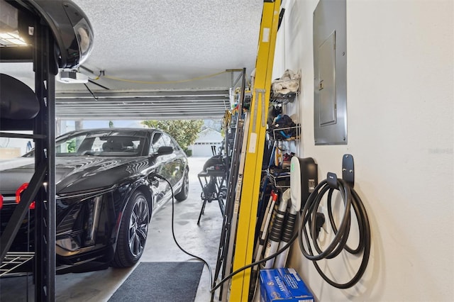 garage with a garage door opener and electric panel