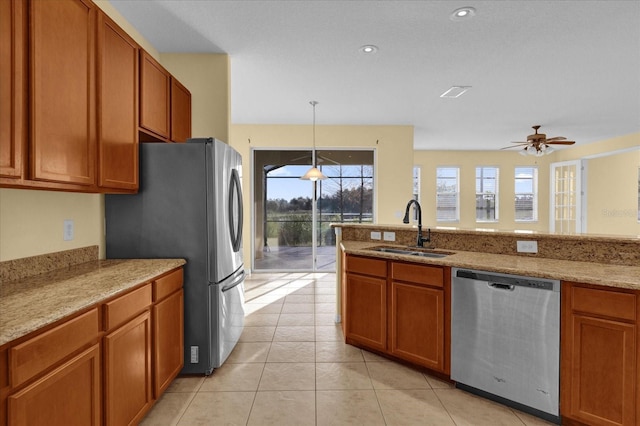 kitchen featuring ceiling fan, sink, pendant lighting, light tile patterned floors, and appliances with stainless steel finishes