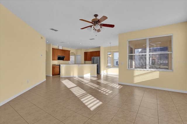 unfurnished living room with ceiling fan and light tile patterned flooring