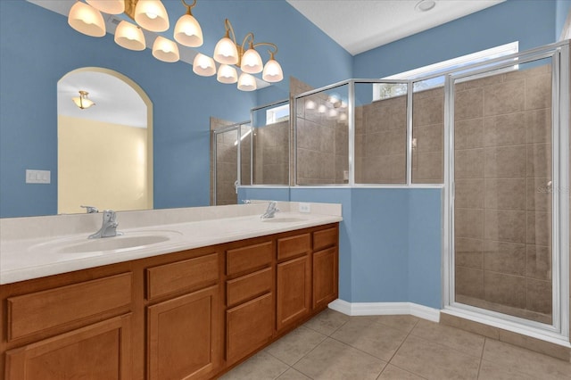 bathroom featuring tile patterned flooring, vanity, and an enclosed shower