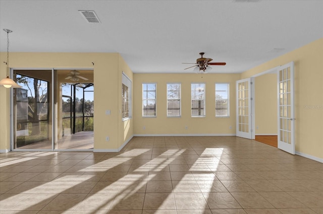 tiled spare room featuring french doors