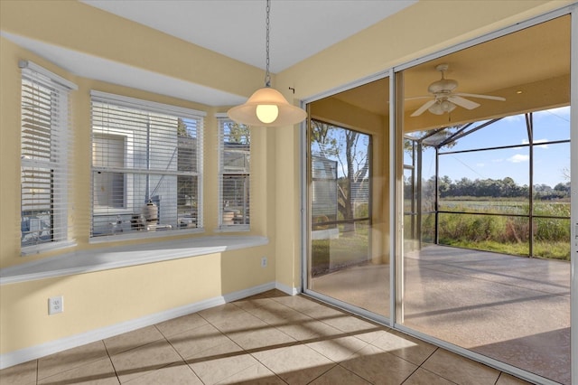 unfurnished dining area with tile patterned floors and ceiling fan