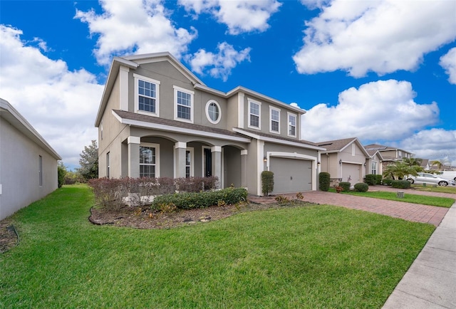 view of front of home featuring a garage and a front lawn