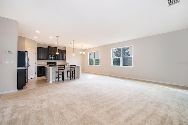 living room featuring a chandelier and light colored carpet