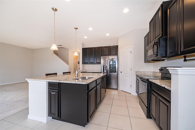 kitchen with sink, hanging light fixtures, a center island with sink, light tile patterned floors, and black appliances