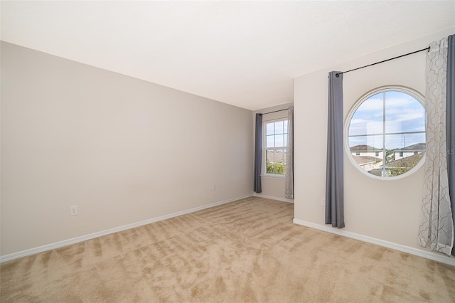 unfurnished room with light colored carpet