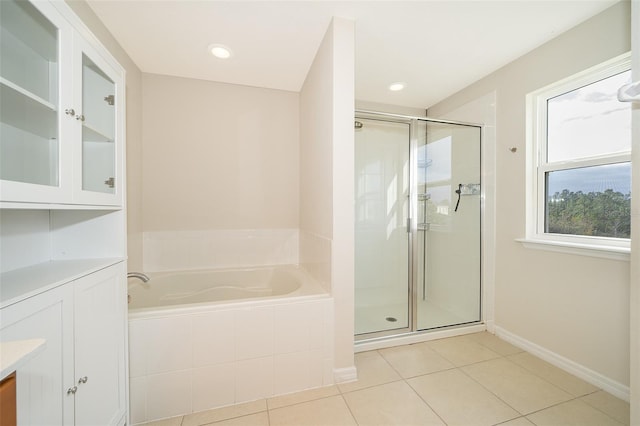 bathroom with shower with separate bathtub, vanity, and tile patterned floors