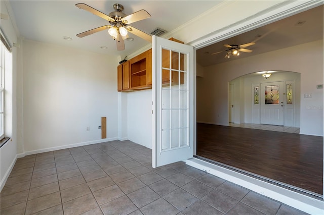 spare room featuring tile patterned floors and ceiling fan