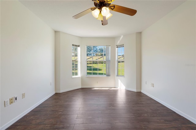 spare room featuring dark wood-type flooring and ceiling fan