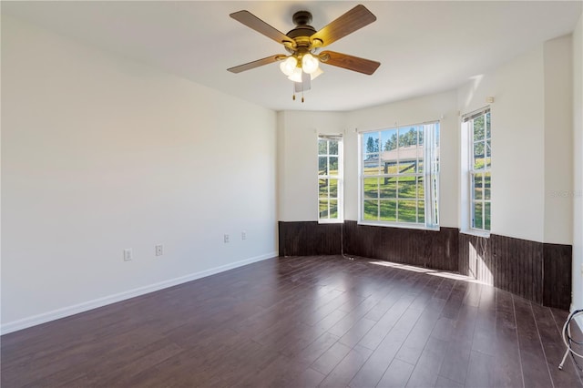 spare room featuring ceiling fan and dark hardwood / wood-style floors