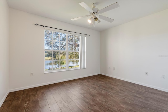 empty room with dark wood-type flooring and ceiling fan