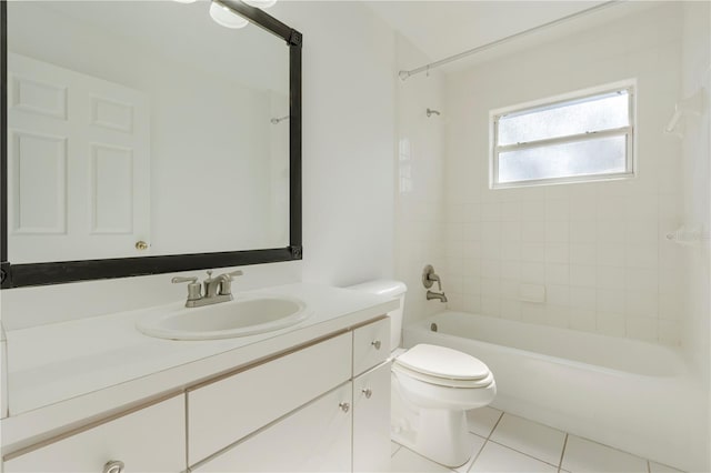 full bathroom featuring vanity, toilet, tiled shower / bath combo, and tile patterned flooring