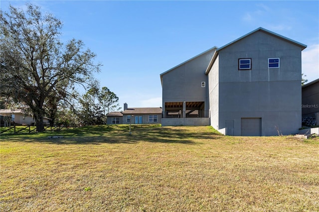 rear view of property with a lawn