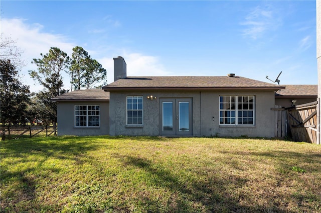 back of property featuring a lawn