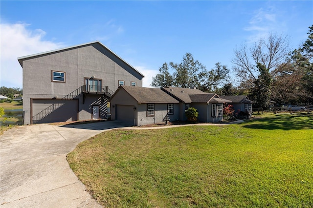 view of front of property with a garage and a front lawn