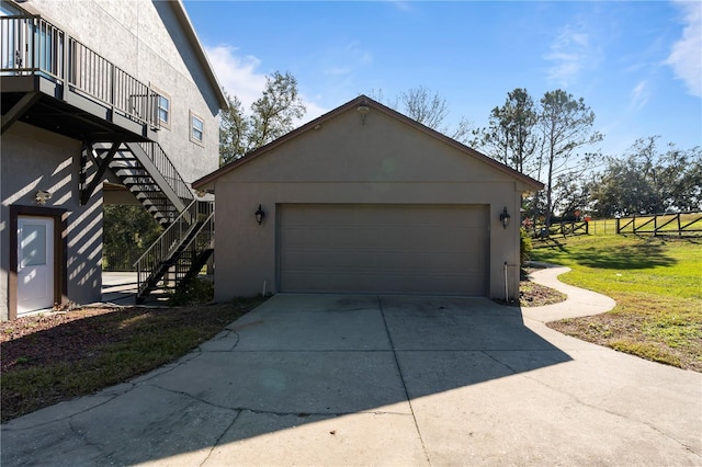 view of side of property with a garage, an outdoor structure, and a yard