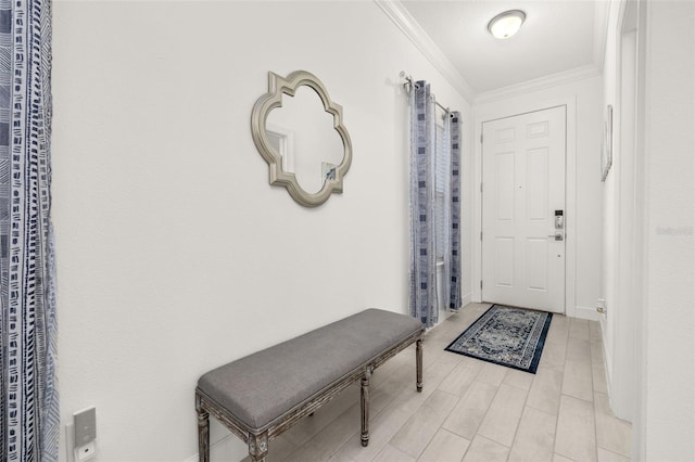 foyer featuring crown molding and light wood-type flooring