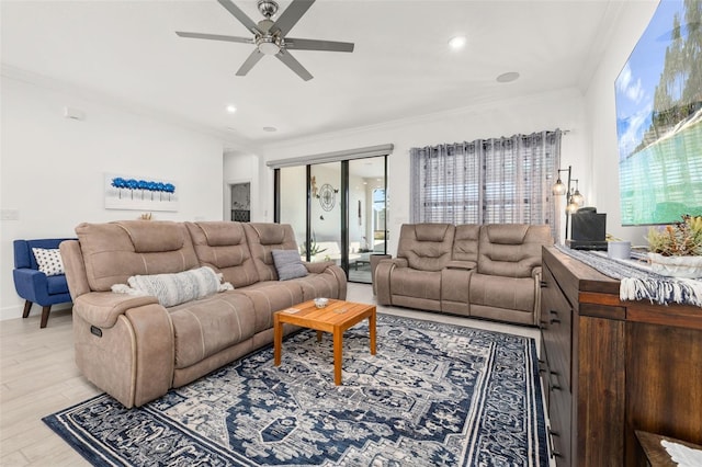 living room with crown molding, ceiling fan, and light wood-type flooring