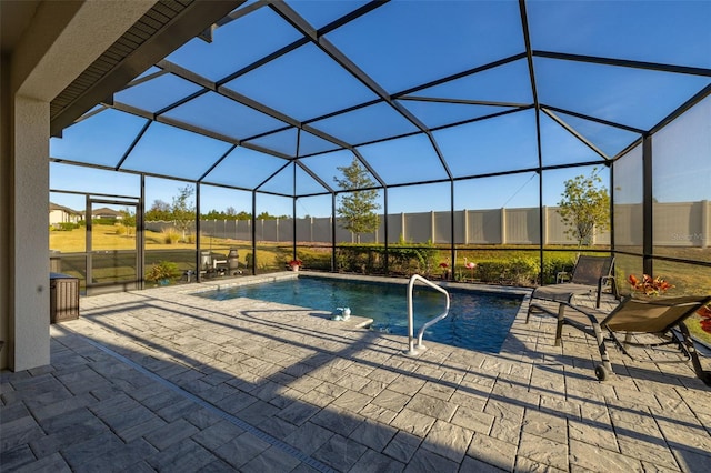 view of pool with a patio and glass enclosure