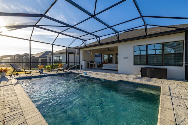 view of pool featuring ceiling fan, a lanai, and a patio