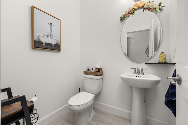 bathroom with tile patterned flooring, sink, and toilet