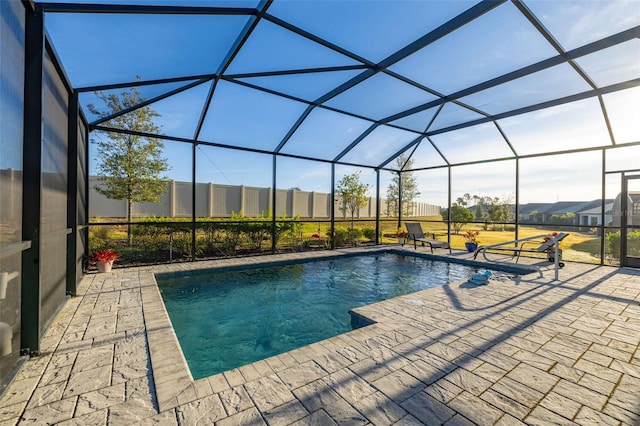 view of pool with a patio and glass enclosure