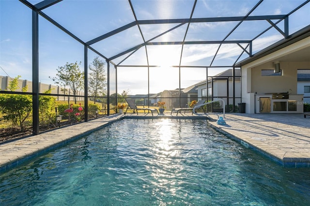 view of swimming pool featuring a patio, a lanai, and area for grilling