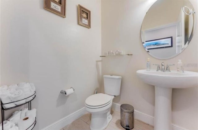 bathroom featuring tile patterned floors, sink, and toilet