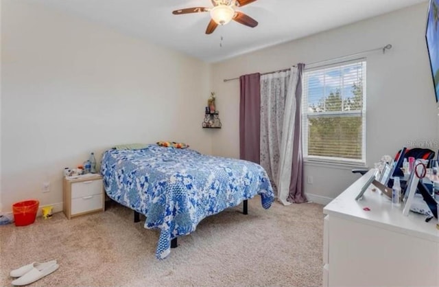 bedroom with ceiling fan and light carpet