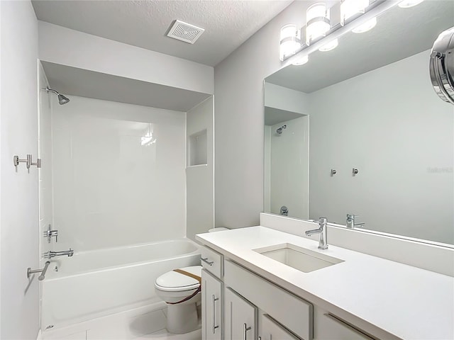 full bathroom with vanity, a textured ceiling,  shower combination, tile patterned flooring, and toilet