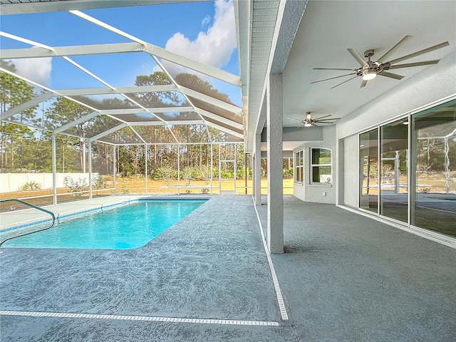 view of pool with ceiling fan, a patio area, and a lanai