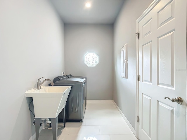 clothes washing area with washer and dryer and sink