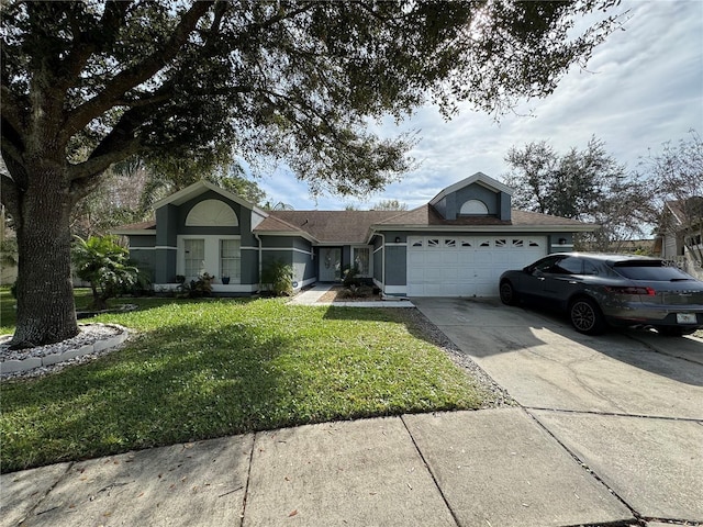 ranch-style house featuring a front yard and a garage