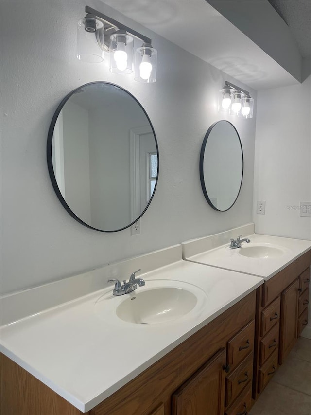 bathroom featuring double vanity, tile patterned floors, and a sink