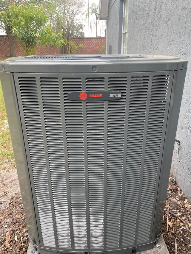 details featuring central air condition unit and stucco siding