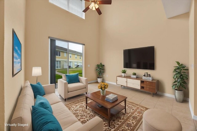 tiled living room with a towering ceiling and ceiling fan