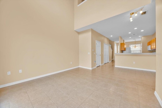 unfurnished living room featuring light tile patterned floors