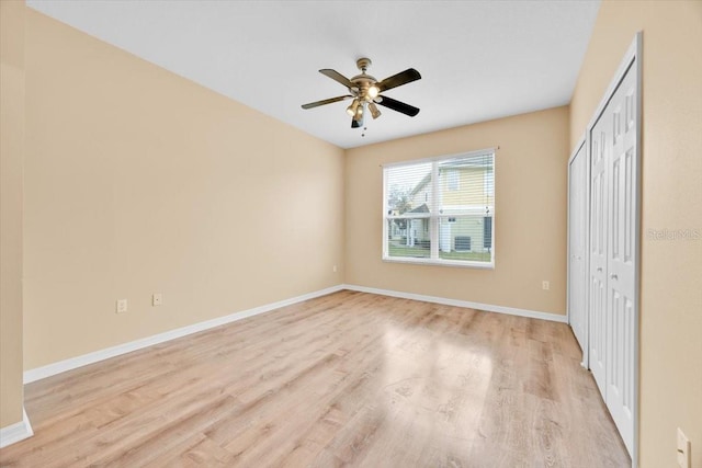 unfurnished bedroom featuring ceiling fan, light hardwood / wood-style floors, and a closet