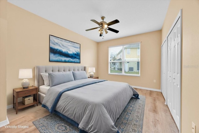 bedroom with ceiling fan, light hardwood / wood-style floors, and a closet