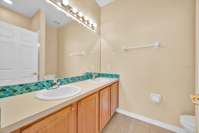 bathroom with vanity, toilet, and tile patterned flooring