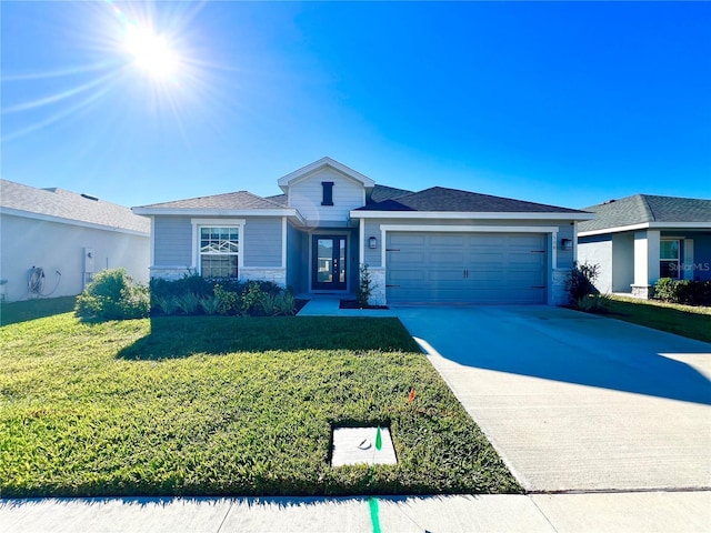 view of front of home with a garage and a front lawn