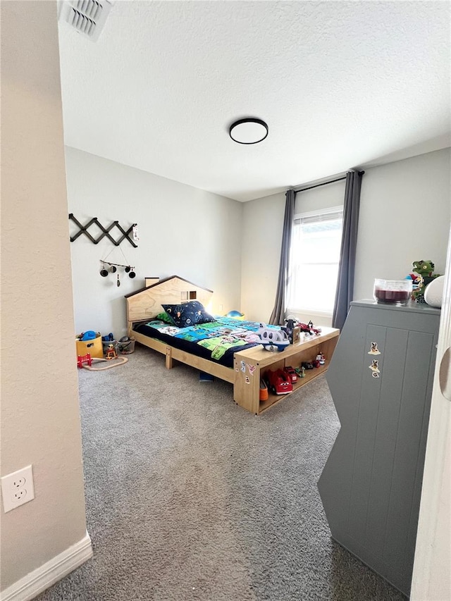 bedroom featuring carpet flooring and a textured ceiling