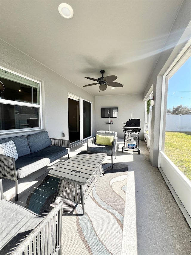 sunroom / solarium featuring ceiling fan