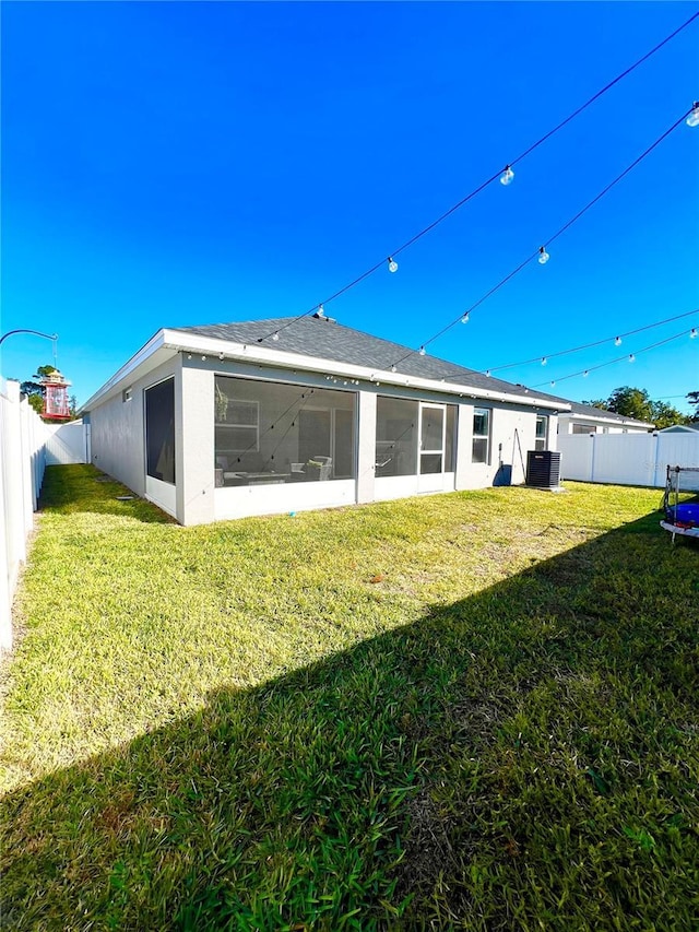 back of property featuring a sunroom and a yard